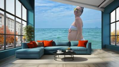 young pregnant woman swim in the sea in summer, tropics, travel Wall mural