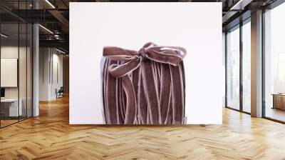 a hank of brown velvet ribbon with bow Wall mural