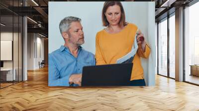 Man and woman smiling professional business people talking using laptop computer working in office. Wall mural