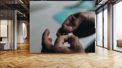 Man cut finger while cooking in kitchen, closeup Wall mural