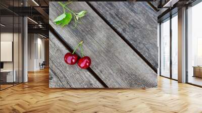 two cherries lie on old wooden boards Wall mural