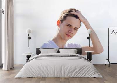 A young man with a white shirt and short hair Wall mural