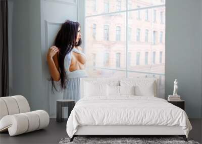 Beautiful sexy girl in white dress by the window. romantic image. fashion indoor portrait of elegant sexy woman in luxurious  dress near the window Wall mural