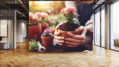 Gardener woman planting flowers in the garden at sunny morning Wall mural