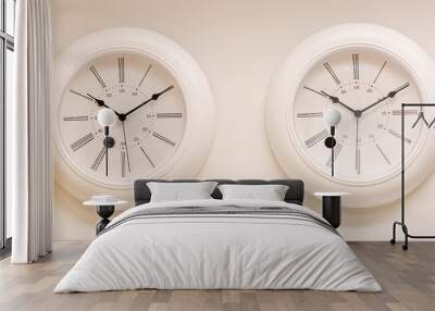 two round wall clocks on a light wall show the same time. Wall mural