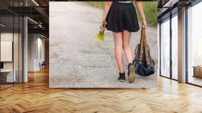 young woman walking on the road with backpack travel concept Wall mural