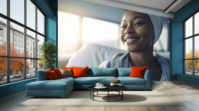 Happy African American Woman undergoing chemotherapy, cancer treatment, remission.  Portrait of bald smiling woman in the hospital. Cured patient, healthy young woman.  Wall mural