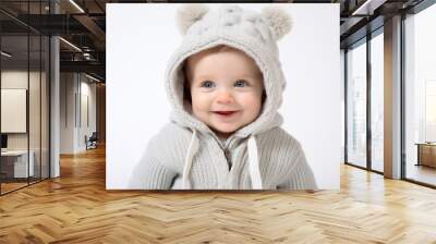 Toddler baby in a cute sweater with ears, isolated on a white studio background. Child smiling and looking away, copy space. Wall mural