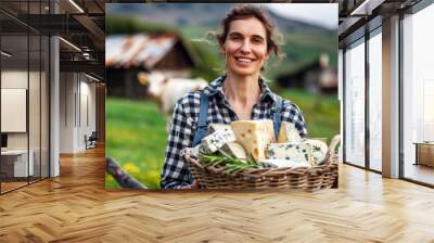 middle age handsome woman holding basket with different cheeses products; modern farm house, green grass and cow on background, family cheese factory, organic natural cheese shop Wall mural