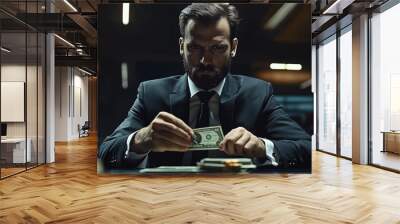 Photo of a businessman in a sleek modern office, intensely counting a substantial sum of money with a serious expression Wall mural