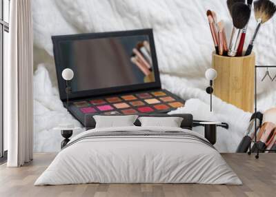 the makeup brush lies on the eyeshadow palette. makeup artist tools Wall mural