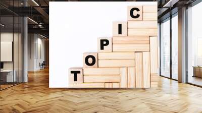 On a light background, wooden blocks and cubes with the text TOPIC Wall mural