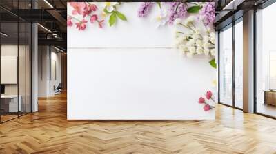 Pretty spring flowers on white wooden background with copy space for your design. Spring background concept Wall mural