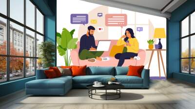 Women and man sitting in a sofa and working online at home. Freelance, online education or social media concept. Wall mural