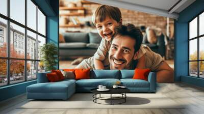 Happy loving daddy and cute boy playing active games at home. Family leisure concept Wall mural