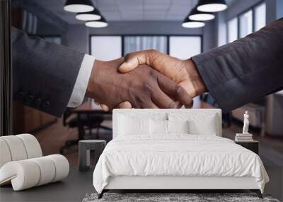 professional businessmen shaking hands while signing a partnership agreement. business moment of two professionals shaking hands symbolizing the successful completion of a deal in a modern office. ref Wall mural