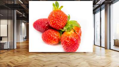 Several red strawberries with leaves on a white background Wall mural