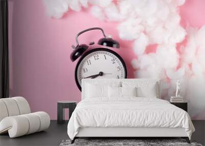 alarm clock on pink background with cloaks Wall mural