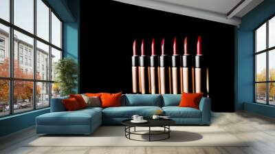 Set of bright lipsticks in shades of red color, studio shot on black background. Red lipstick isolated on black background. Close-Up Of Various Lipsticks Against Black Background Wall mural