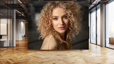 portrait of a beautiful young girl with curly hair looking at the camera Wall mural