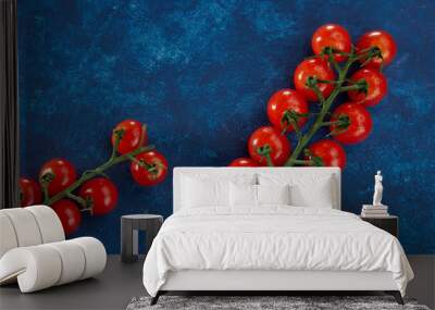 Sweet ripe cherry tomatoes lie against a classic blue background.Red.Blue.Healthy food.Fresh vegetable Wall mural