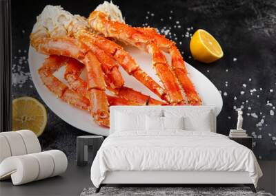 Crab legs in a plate on a dark background. Ready to eat. Wall mural