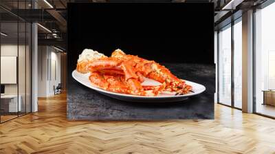 Crab legs in a plate on a dark background. Ready to eat. Wall mural