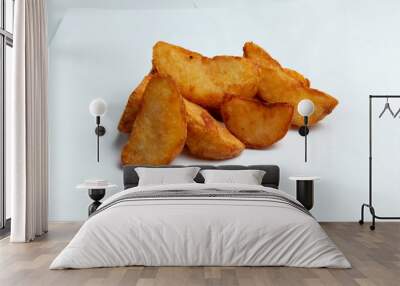 Fried potato wedges. On a white background. Wall mural