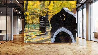 Old islamic cemetery, funeral and burial of muslim. A grave with a stone with crescent moon. Black gravestone Wall mural