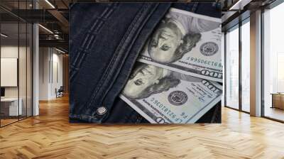 One hundred dollar banknote money in pocket jeans pants background texture. 100 dollar bill close up Wall mural