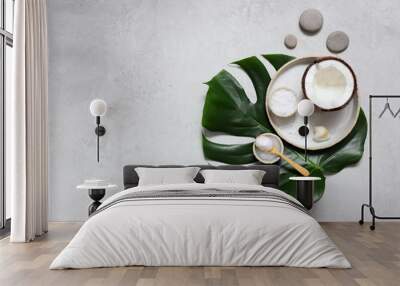 Spa setting with monstera leaves top View. Natural products for Spa and massage with coconut. Wall mural