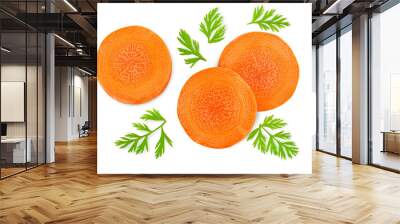 chopped carrot slices with leaves on a white isolated background, top view Wall mural