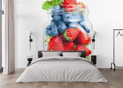 glass jar with grapes, strawberries and blueberries on a white isolated background Wall mural