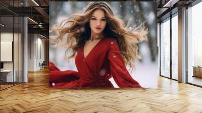 hot beautiful girl with full lips and long hair and rounded shapes dances in full length in a red dress on the snow in a snowfall Wall mural