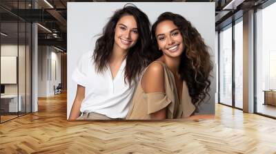 Two happy beautiful friends women posing together  Wall mural