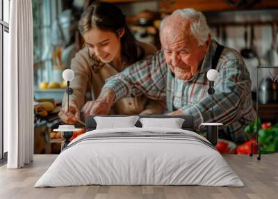 An elderly man cooks food with his granddaughter, a teenage girl learns from the experience in a cozy kitchen Wall mural