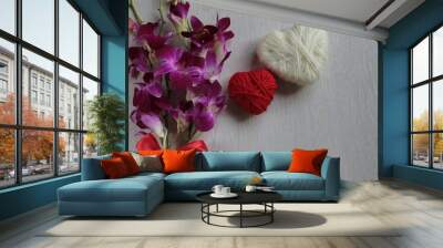 A bouquet of purple orchids and two hearts in red and white. Wall mural