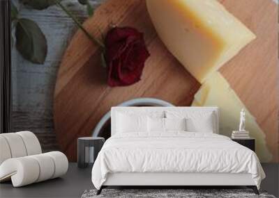 A mug of black coffee, cheese and a red rose. Wall mural