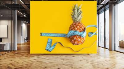 Blue measuring tape around fresh pineapple with copy space  as exercise, health and diet concept. Wall mural