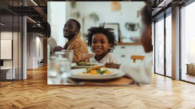 A family is sitting around a table eating dinner Wall mural