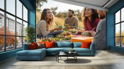 A group of people are sitting on a grassy field Wall mural