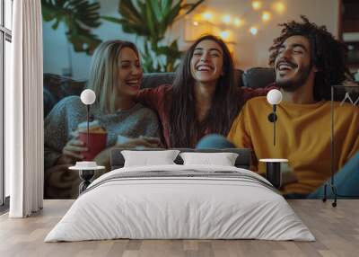 Three people are sitting on a couch, laughing and enjoying each other's company Wall mural