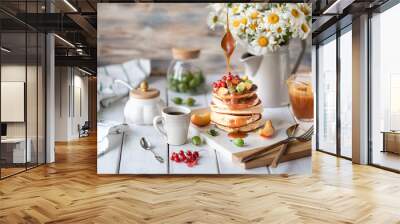 Cornmeal pancakes with salted caramel served with berries and fruits on a white wooden background. Wall mural