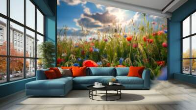 A vibrant wildflower meadow under a sunny sky with fluffy clouds Wall mural