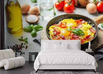 Freshly cooked scrambled eggs with bacon and tomatoes in a skillet Wall mural