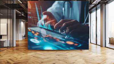 Close-up of a businessman's hands pointing at a healthcare business graph on a laptop screen, with stethoscope and medical reports in the background Wall mural