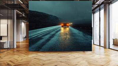 A car driving on a wet road in a dark, stormy landscape during nighttime Wall mural