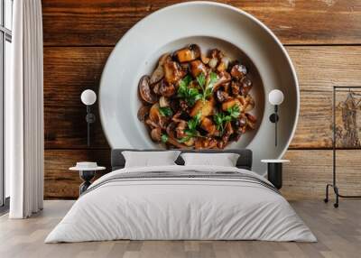 Sautéed mushrooms with herbs served in a bowl on rustic wooden table Wall mural