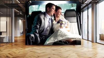 couple sitting on backseat of the car and looking out of window Wall mural