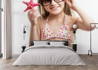 happy smiling girl in sunglasses posing with red starfish Wall mural